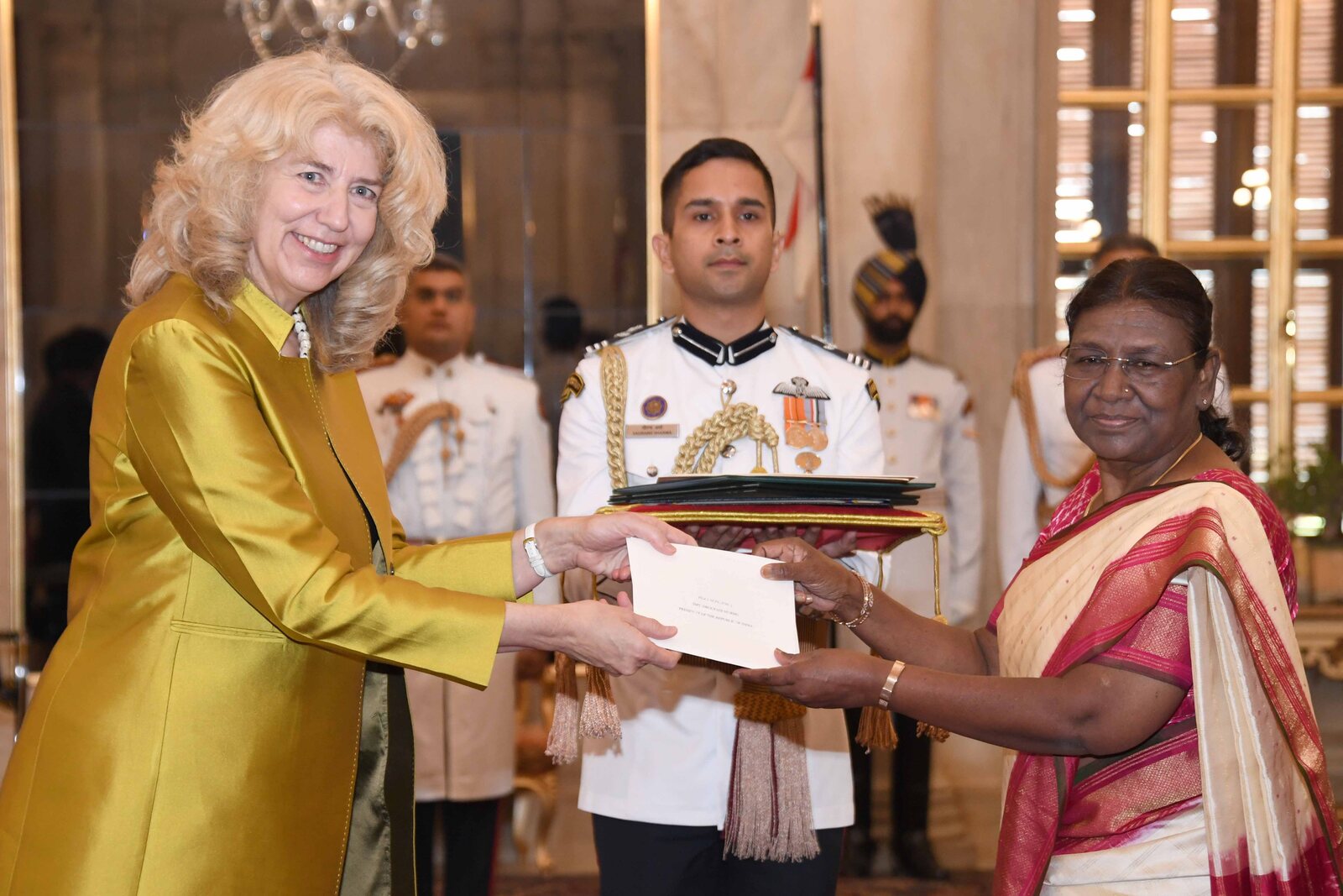 An ambassador presents her letters of credence to President Droupadi Murmu at Rashtrapati Bhavan, attended by an officer of the President's Bodyguard