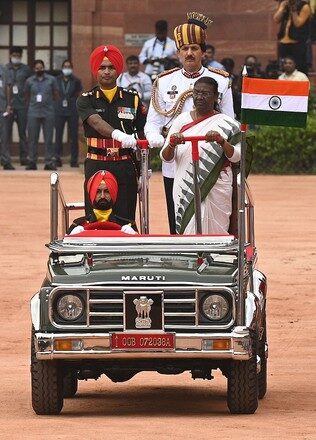 President Droupadi Murmu inspecting a ceremonial guard of honour from an open vehicle