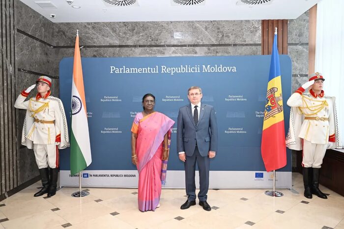 President Droupadi Murmu with the President of the Parliament of Moldova between the two national flags