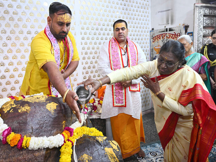 President Droupadi Murmu offering prayers at a temple during a ritual