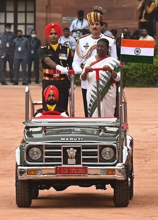 President Droupadi Murmu inspecting a ceremonial guard of honour from an open vehicle